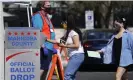  ?? Photograph: Ross D Franklin/AP ?? Voters drop off ballots as volunteers look on at the Maricopa county recorder's office in Phoenix, Arizona.