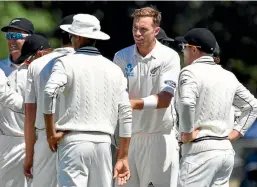  ?? PHOTO: PHOTOSPORT ?? New Zealand seamer Tim Southee, centre, is surrounded by teammates after claiming his 200th test wicket in Christchur­ch yesterday.