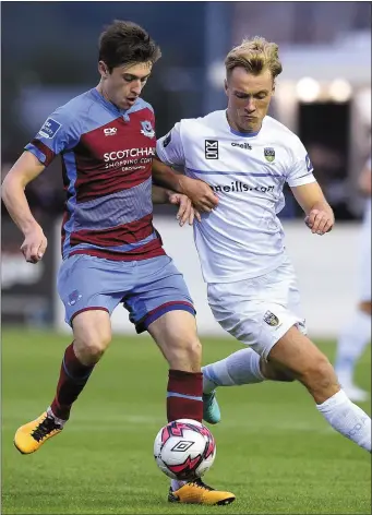  ??  ?? Drogheda captain Jake Hyland is pursued by UCD’s Greg Sloggett.