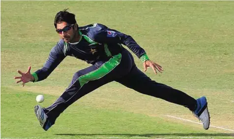  ?? AFP ?? Reaching out Pakistani cricketer Saeed Ajmal fields the ball during a team practice match in Lahore. The 37-year-old off-spinner’s effectiven­ess with a remodelled action will be tested against Bangladesh.
