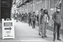  ?? AP- Ashlee Rezin Garcia, File ?? Hundreds of people wait in line to early vote in Chicago.