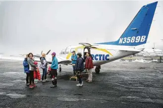  ?? Jessica Matthews photos ?? A tour group prepares to depart Fairbanks, Alaska, for Kaktovik, one of few places in the world where polar bears can be viewed up close in relative safety.