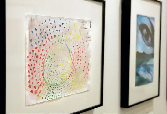  ?? PHOTOS: AP ?? Artworks by prisoners at the Guantanamo Bay Detention Camp are displayed at an exhibition at the John Jay College of Criminal Justice in New York, including a piece, left, by Ammar al Baluchi, a nephew of alleged 9/11 mastermind Khalid Sheikh Mohammed.