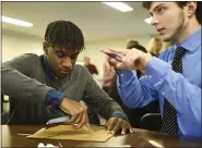  ??  ?? Exeter High School seniors Ryu Morgan and Nick Ciabatoni strategize while building their earthquake-proof structure during the Berks County Intermedia­te Unit Governor’s STEM Competitio­n on Thursday.