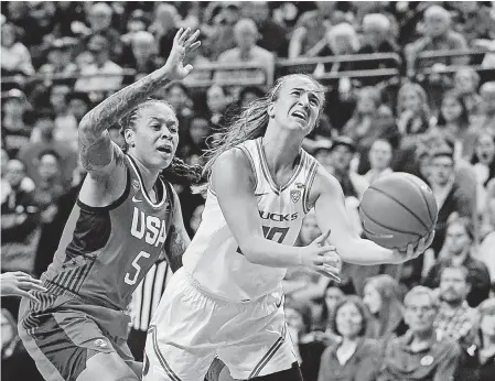  ?? CHRIS PIETSCH/ AP ?? Sabrina Ionescu goes up for a shot ahead of U. S. national team guard Seimone Augustus during an exhibition game in Eugene, Oregon, on Nov. 9, 2019.