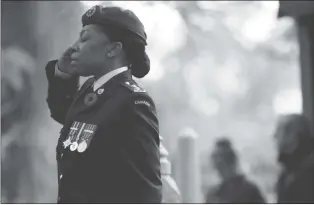  ?? CP PHOTO ?? Lt. Kerry-ann Cameron salutes during Remembranc­e Day ceremonies at God’s Acre Veteran’s Cemetery in Victoria, B.C., on Sunday.