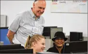  ?? CORNELIUS FROLIK / STAFF ?? University of Dayton student Claire Vogel helps prepare and submit 58-year-old Teresa Rainey’s tax returns Saturday at the Job Center. Volunteer Gary Dowdy also helped low- and moderate-income residents file their returns.