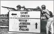  ??  ?? Indian troops stand guard Dec. 8, 1971, at a road crossing to Dacca after capturing Jessore town, East Pakistan.