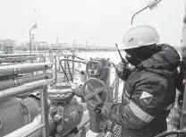  ?? Andrey Rudakov / Bloomberg file photo ?? A worker adjusts a pipeline valve in January at the Gazprom Slavyanska­ya compressor station, the starting point of the Nord Stream 2 gas pipeline, in Ust-Luga, Russia.