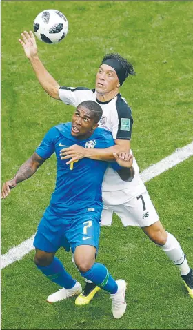  ?? AP/MICHAEL SOHN ?? Costa Rica’s Christian Bolanos (right) challenges for the ball with Brazil’s Douglas Costa in Brazil’s 2-0 victory Friday. The victory allows Brazil to advance into the knockout stage of the World Cup.