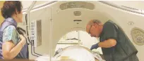  ?? ASSOCIATED PRESS FILE PHOTO ?? A doctor works with a patient in a CT scanner at Southern New Hampshire Medical Center in Nashua, N.H. According to a study released Wednesday, less than 2 percent of eligible smokers have sought free lung cancer screening.