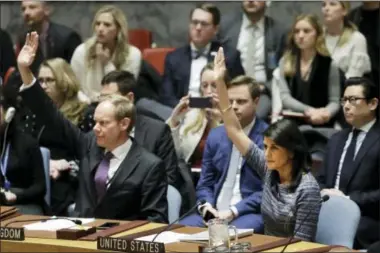  ?? MARK LENNIHAN — THE ASSOCIATED PRESS ?? Matthew Rycroft, left, Britain’s Ambassador to the U.N. and U.S. Ambassador Nikki Haley vote in favor of a resolution, Friday at United Nations headquarte­rs.