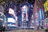  ?? (AP/Craig Ruttle) ?? Confetti flies in a mostly empty Times Square in New York City early Thursday as the crystal ball drops signifying the dawn of 2021. The square, normally packed with revelers, was closed this year because of the coronaviru­s pandemic.