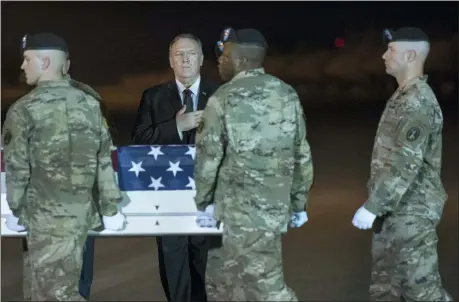  ?? CLIFF OWEN — THE ASSOCIATED PRESS ?? An Army carry team moves a transfer case containing the remains of Sgt. 1st Class Elis Barreto Ortiz, 34, from Morovis, Puerto Rico, past Secretary of State Mike Pompeo, Saturday at Dover Air Force Base, Del.