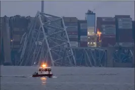  ?? MATT ROURKE — THE ASSOCIATED PRESS ?? A container ship rests against wreckage of the Francis Scott Key Bridge in Baltimore, Md., near sunrise on Wednesday.