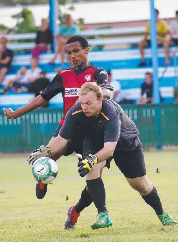  ?? Pictures: STEWART MCLEAN ?? ATTACK: Leichhardt's Kaleab Agegnehu and Stratford's goalie Sean McLaughlin compete for possession during the FNQ Football Premier League game at Stratford.