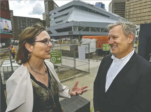  ??  ?? Library CEO Pilar Martinez and city architect Carol Belanger talk architectu­re Tuesday in front of the revamped Stanley A. Milner Library.
Ed Kaiser
