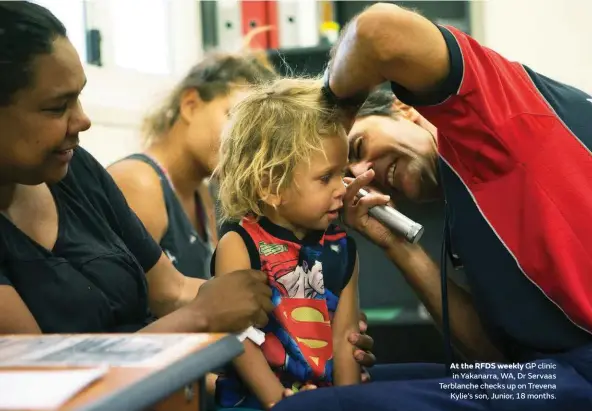  ??  ?? At the RFDS weekly GP clinic in Yakanarra, WA, Dr Servaas Terblanche checks up on Trevena Kylie’s son, Junior, 18 months.