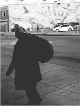  ?? USA TODAY ?? A homeless woman heads to a shelter in Denver, where advocates worry that the homeless and poor will feel the biggest effect of HQ2 as people get priced out of neighborho­ods by well- paid Amazon workers.