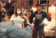  ??  ?? Jere Eaton, right, a supporter of Democratic mayoral candidate Caroline Simmons, congratula­tes her on camera for winning her primary election during a party for her at campaign headquarte­rs at Third Place by Half Full Brewery on Pacific Street in Stamford on Tuesday.