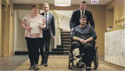  ?? TYLER PASCIAK LARIVIERE/SUN-TIMES ?? Bradley Cosgrove, a partner at Clifford Law Offices, pushes his client Antonio DeAngelo’s wheelchair into a news conference at the law firm’s Loop office Friday.