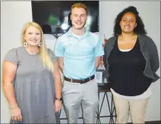  ?? Westside Eagle Observer/SUSAN HOLLAND ?? Three new hires at Gravette Public Schools pose after being introduced at a special meeting of the Gravette School Board Monday evening, Aug. 1. Pictured are Courtney Malott, who will be a special ed teacher at Gravette Upper Elementary; Seth Duke, who will teach science and math at Gravette Middle School and serve as assistant high school and junior high basketball coach; and Leah Laramore, who will teach math at Gravette High School.