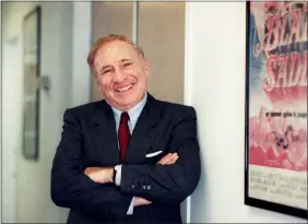  ?? AP PHOTO/NICK UT, FILE ?? FILE - Actor-director-writer Mel Brooks poses next to a framed poster of his 1974film “Blazing Saddles” in Los Angeles on July 23, 1991. Brooks released a memoir, “All About Me!: My Remarkable Life in Show Business.”