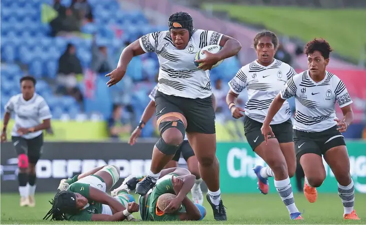  ?? Photo: ?? Vodafone Fijiana XVs tighthead prop Siteri Rasolea on a rampaging run against South Africa with Bitila Tawake next to her and Bulou Vasuturaga (right) in support during the 2022 Women’s Rugby World Cup in Auckland, New Zealand. Fijiana XVs won 21-17.