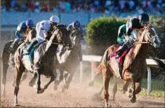  ?? Thomas Metthe / Associated Press ?? Cyberknife, right, ridden by Florent Geroux, heads through the first turn on the way to winning the Arkansas Derby.