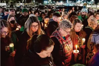  ?? Billy Schuerman/Associated Press ?? Residents of Newport News, Va., gather for a vigil Monday night for Abigail Zwerner, 25, a teacher who was shot allegedly by a 6-year-old student at Richneck Elementary School.