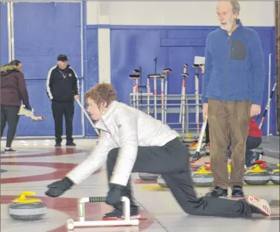  ?? CHRISTIAN ROACH/CAPE BRETON POST ?? Cynthia Boutilier is taught how to curl by Ron Labelle during the Taste of Winter: Learn to Curl event at the Sydney Curling Club on Saturday.