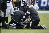  ?? KELVIN KUO — THE ASSOCIATED PRESS ?? Raiders cornerback Trayvon Mullen is treated on the field during the first half against the Los Angeles Chargers on Sunday in Carson.