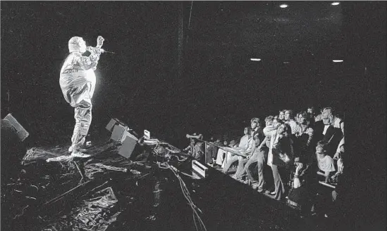  ?? Bobbie Watson Whitaker ?? BOOJI BOY, a character created in the early 1970s by the art-punk band Devo, takes the stage during a performanc­e in 1978. The audience isn’t so sure about it all.