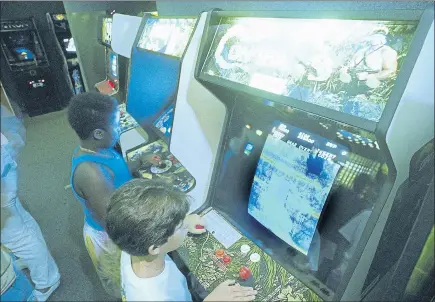  ?? ASSOCIATED PRESS ARCHIVES ?? Carlos Tunnerman, 10, plays the “Contra” video game at an arcade in Miami, Florida, in 1987. Decades of study have failed to validate the most prevalent fear, that violent games encourage violent behavior.