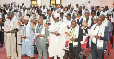  ?? Photo: Ikechukwu Ibe ?? A cross section of the certified members of Chartered Institute of Forensics and Certified Fraud Investigat­ors of Nigeria (CIFCFIN) taking the oath of allegiance to the institute during its 4th direct membership graduation/induction ceremony and award of Fellowship in Abuja yesterday.