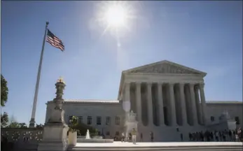  ??  ?? People visit the Supreme Court in Washington on Monday as justices issued their final rulings for the term, in Washington. The high court is letting a limited version of the Trump administra­tion ban on travel from six mostly Muslim countries take...