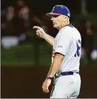  ?? John Hefti / Associated Press ?? UConn coach Jim Penders gestures for a pitching change during the ninth inning of an NCAA college baseball tournament super regional game against Stanford on Saturday in Stanford, Calif. UConn won 13-12.