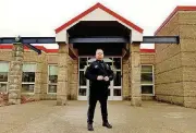  ??  ?? Ken Thaxter stands outside Howard Elementary. About 40 cities and towns in Massachuse­tts still support the DARE program, but where there were once 800 officers, only 140 remain today.