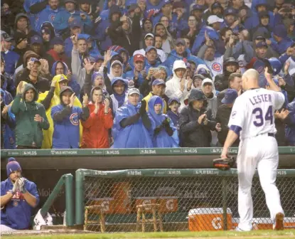  ?? | NAM Y. HUH/ AP ?? Jon Lester gets an ovation from Cubs fans while leaving the game in the eighth inning Wednesday.