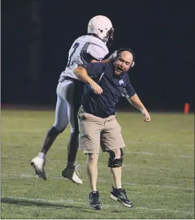  ?? OWEN MCCUE - MEDIANEWS GROUP FILE ?? Pottstown head coach Jeff Delaney, right, and quarterbac­k Joneil Oister celebrate after Oister’s fourth-quarter conversion during a past win over Octorara.