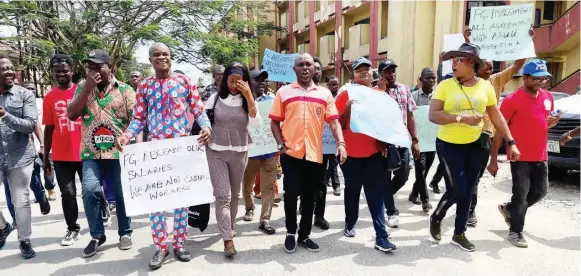  ?? PHOTO: NAN ?? Chairman, Academic Staff Union of Universiti­es, University of Calabar branch, Dr. John Edor ( middle) and other members of the union, during a peaceful protest on campus to demand payment of their eight months salary arrears from the Federal Government in Calabar… yesterday.