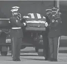  ?? CHARLIE RIEDEL/AP ?? A joint services military bearer team carries the casket of former Sen. Bob Dole, R-kan., after it arrived in Salina, Kan., on Friday.