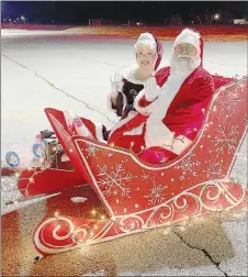  ?? COURTESY PHOTO ?? Santa Claus and Mrs. Claus didn’t fly through the air pulled by reindeer for Prairie Grove’s Reverse Christmas Parade of Lights on Saturday night but they did wave from their sleigh to hundreds of children who rode by in their vehicles.