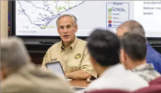  ?? PHOTOS BY STEPHEN SPILLMAN / FOR AMERICAN STATESMAN ?? Gov. Greg Abbott speaks during a storm and flooding briefing in the state emergency command center at Texas Department of Public Safety headquarte­rs in Austin on Friday as state officials monitor the remnants of Tropical Storm Harvey.