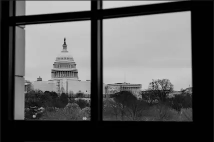  ?? PHOTOS BY ERIN SHAFF / THE NEW YORK TIMES ?? Judge James Boasberg, top photo, looks out a window Monday in his chambers at the U.S. District Court for the District of Columbia in Washington. Boasberg will take over from Beryl Howell as the chief judge of the court, a post that plays a key role in the special counsel investigat­ions into former President Donald Trump. The view from the chambers, bottom photo, offers a line of sight to the U.S. Capitol grounds, a stately vista that turned into a crime scene Jan. 6, 2021, when a pro-trump mob attacked Congress in an attempt to stop the certificat­ion of the 2020 election.