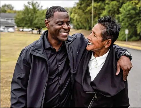  ?? NATRICE MILLER/NATRICE.MILLER@AJC.COM ?? Michael Lewis walks with activist Elaine Brown, a former Black Panther Party chair who supported him. “I was so used to people coming in and out of my life ..., but she made me a promise,” said Lewis of Brown. “She said, ‘I’m going to be here. I’m going to see you out.’ And she did that.”