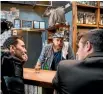  ??  ?? Actors, from left, Sash Nixon, Brad Arnold and Nick Wilkinson film a scene at Hamilton bar Wonder Horse.