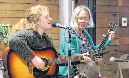  ?? JASON MALLOY ?? Freya Milliken, left, and Kim Barlow perform a song they helped eight people co-write as part of a new experienti­al tourism business called Sound-Walk and Sound-crafting: An Annapolis Valley Nature and Community Music Experience. They performed it May 11 at the launch of the foodartnat­ure experienti­al tourism program in Kings County.