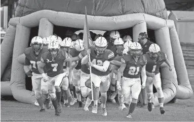  ?? DARRYL WEBB/FOR THE REPUBLIC ?? Valley Christian players charge the field before their game against Snowflake on Aug. 27 at Valley Christian High School in Chandler.