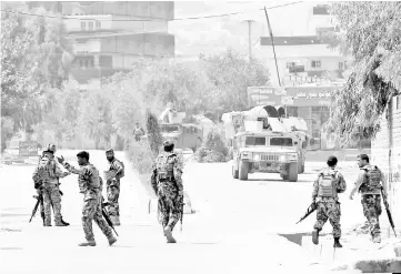  ??  ?? Afghan National Army (ANA) soldiers arrive at the site of gunfire and attack in Jalalabad city, Afghanista­n. — Reuters photo